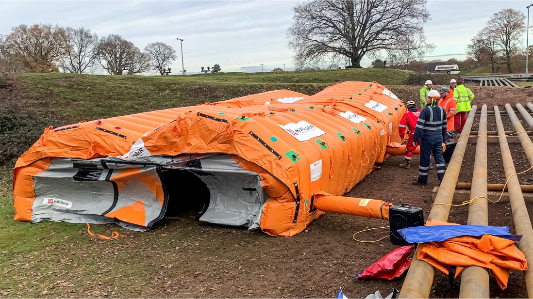 Fast Tent being inflated next to pipes