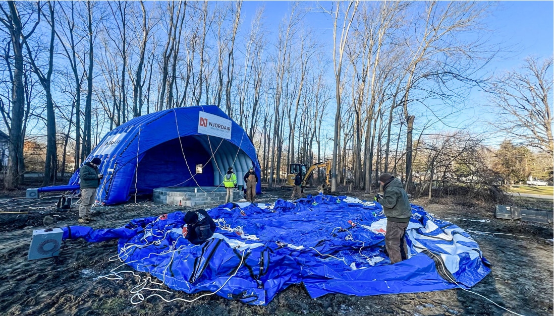Blue Fast tent module lying on the ground awaiting inflation