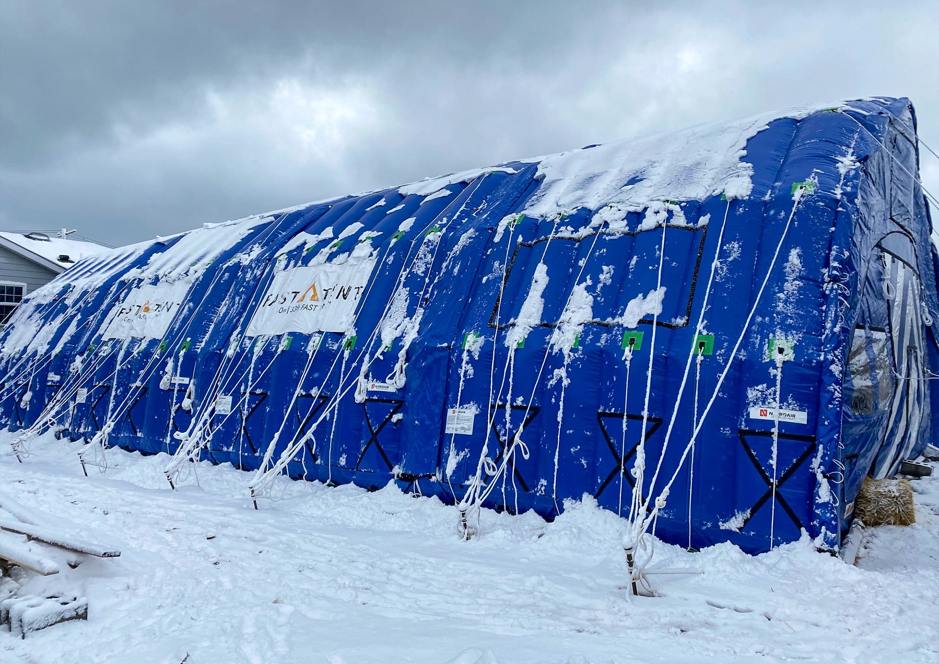 Side view of blue CA-10 Fast Tent in the snow