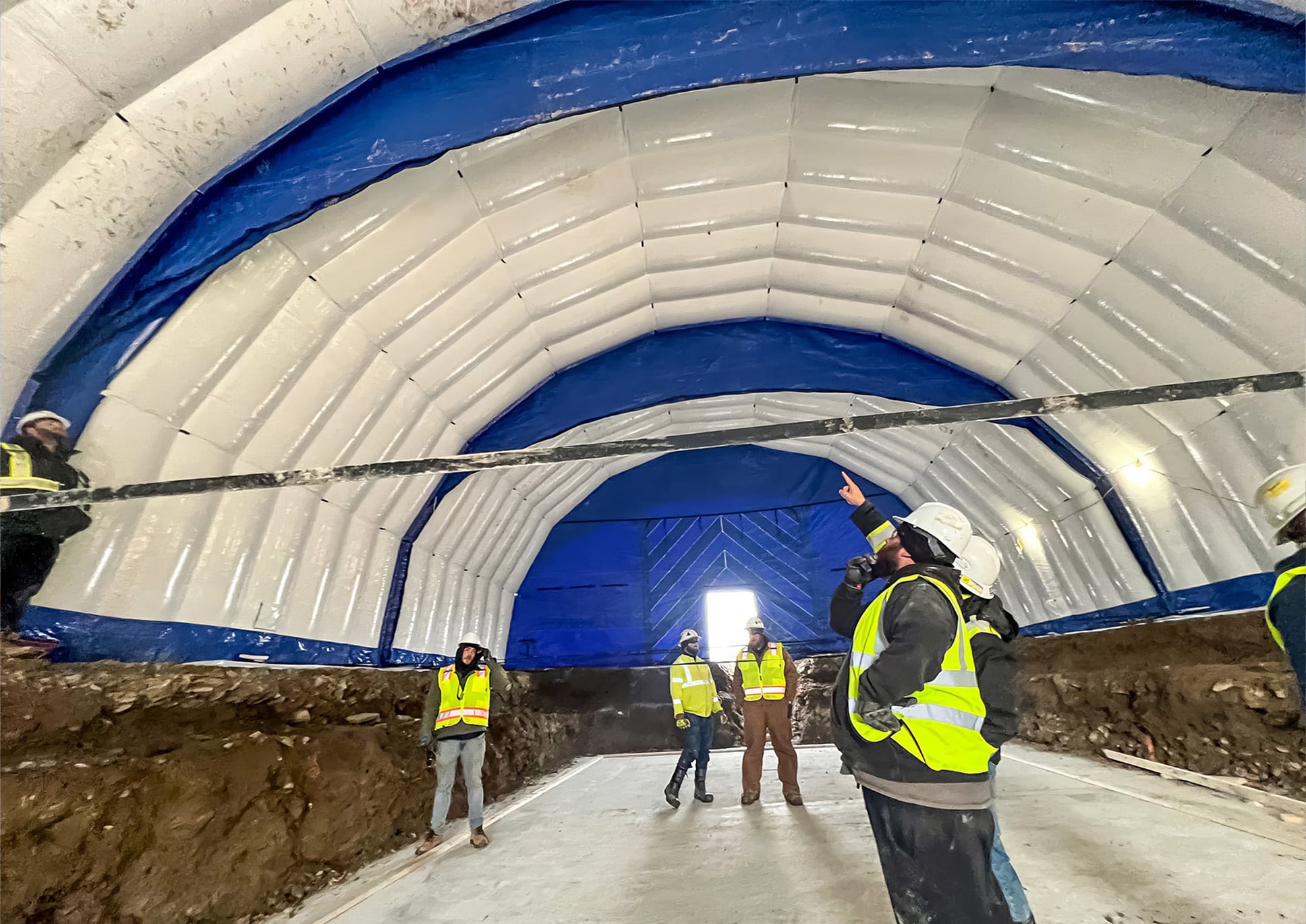 People inside Fast Tent pointing at the roof